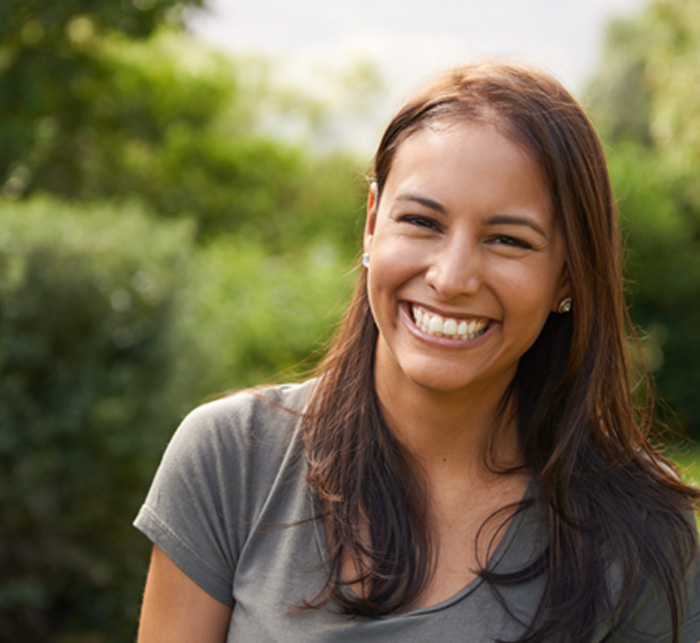 A beautiful young woman smiling outdoors