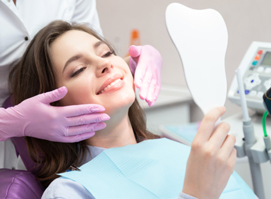 A woman admiring the results of her smile makeover