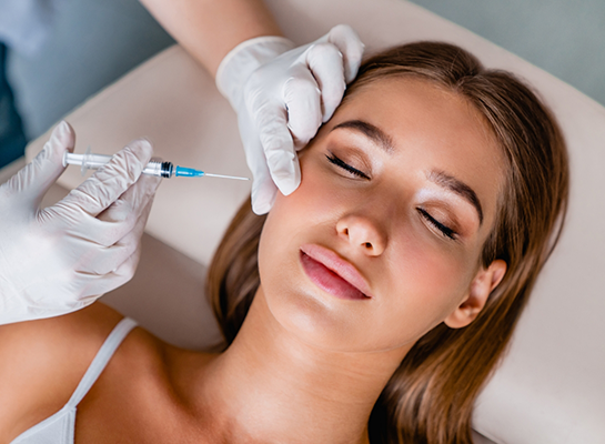 Young woman receiving injection in her cheek