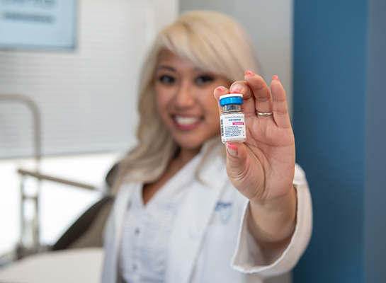 Doctor Santos holding a Botox vial