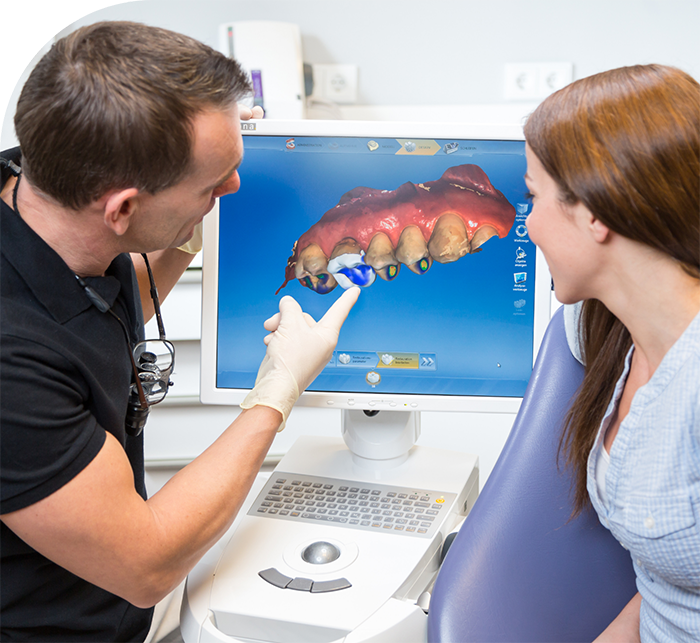 Dentist showing a patient a digital impression of their teeth on screen