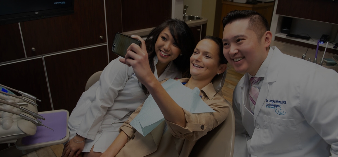 Dental patient taking a selfie with White Marsh dentist and assistant