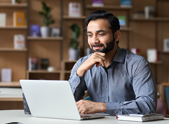 Man sitting at table and using laptop