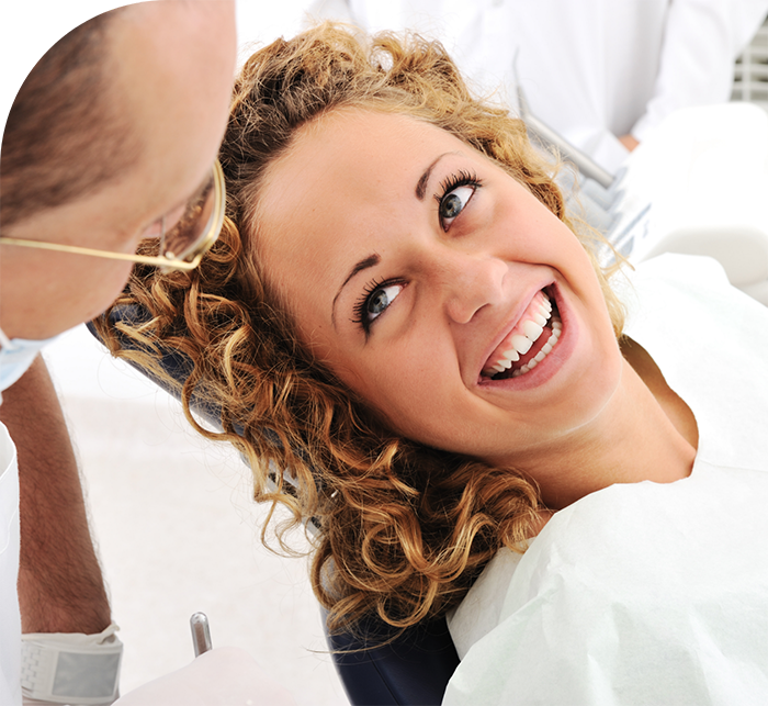 Dental patient smiling at her dentist after root canal treatment in White Marsh